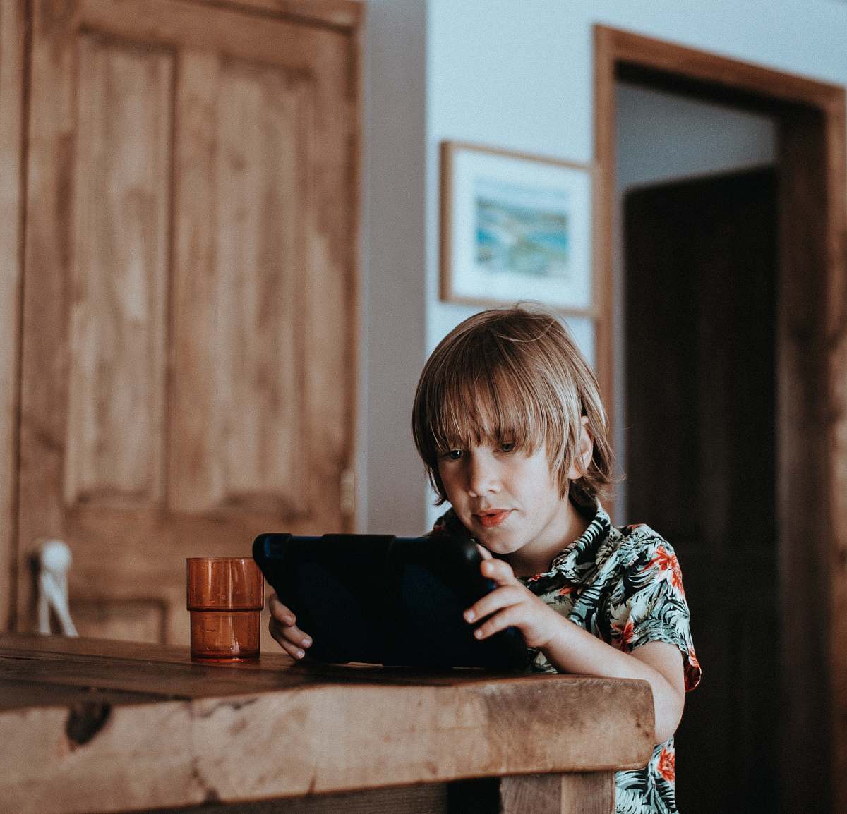 child selective focus of child using tablet computer on table childhood