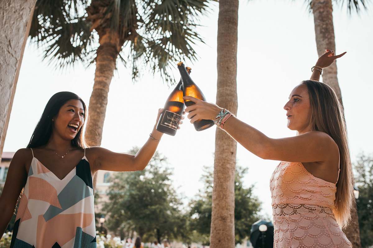 human two woman holding beer bottles person