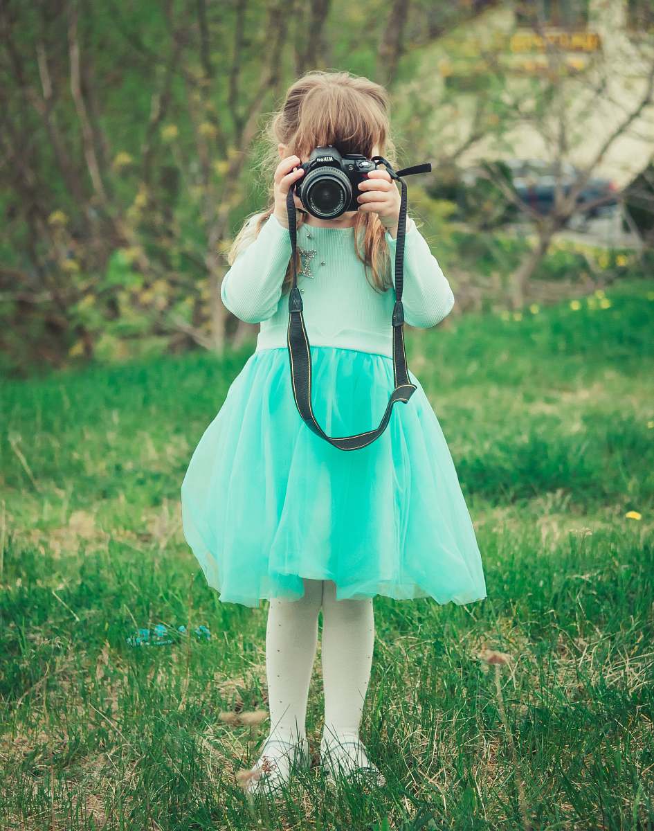 human girl holding black DSLR camera photo