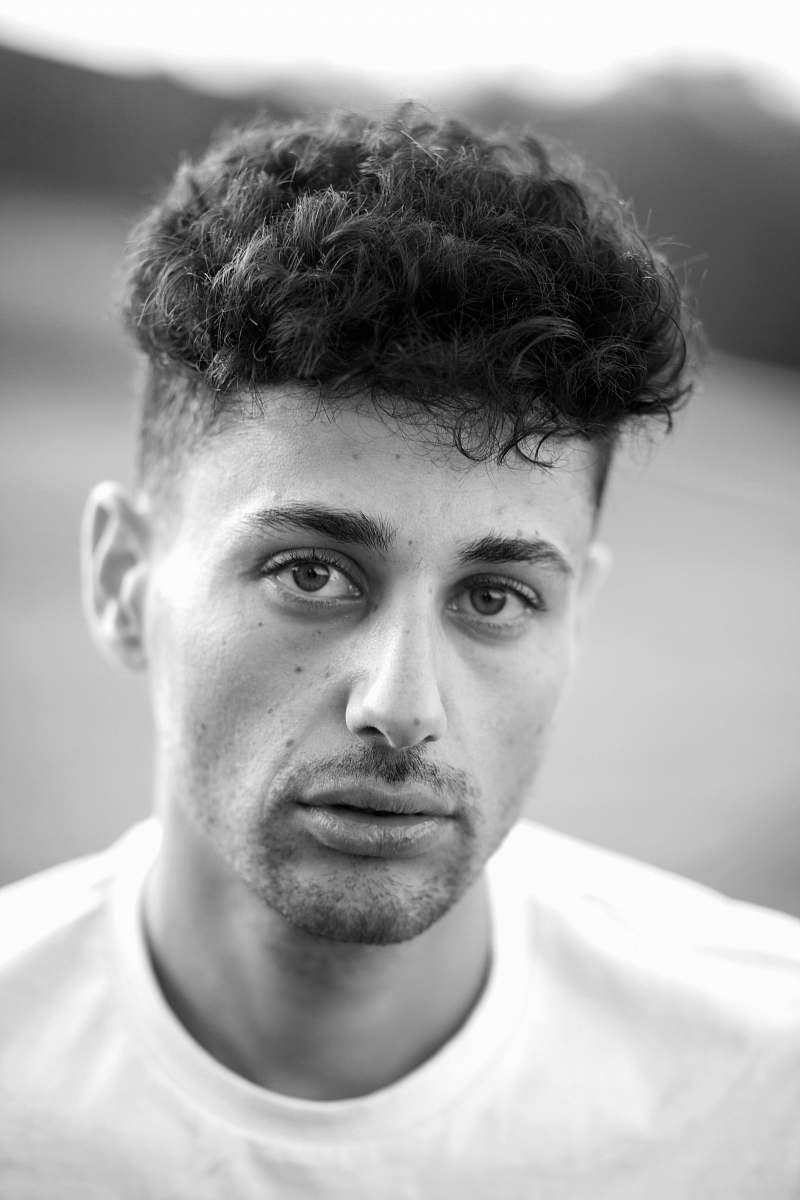 face grayscale photography of man wearing crew-neck shirt black-and-white
