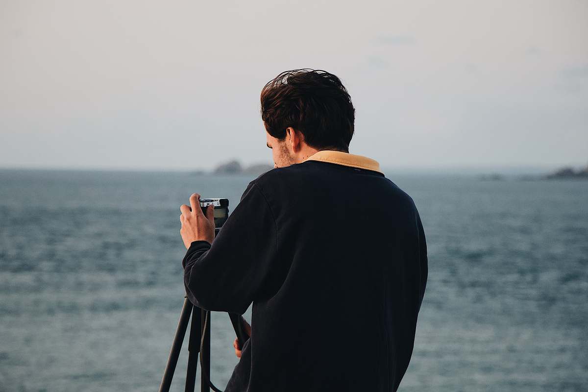 human man holding camera photographer