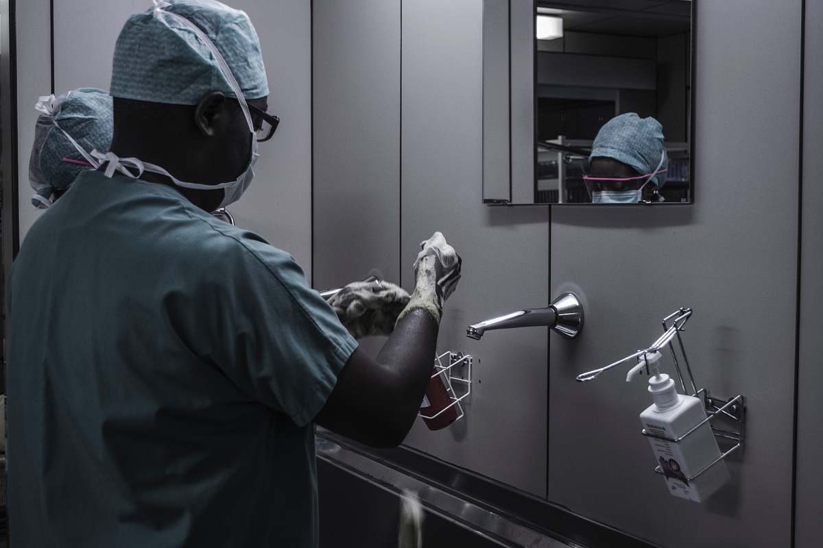 human man wearing surgical suit near mirror medical