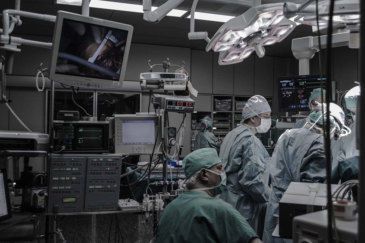 human people wearing surgical clothes inside operating room people