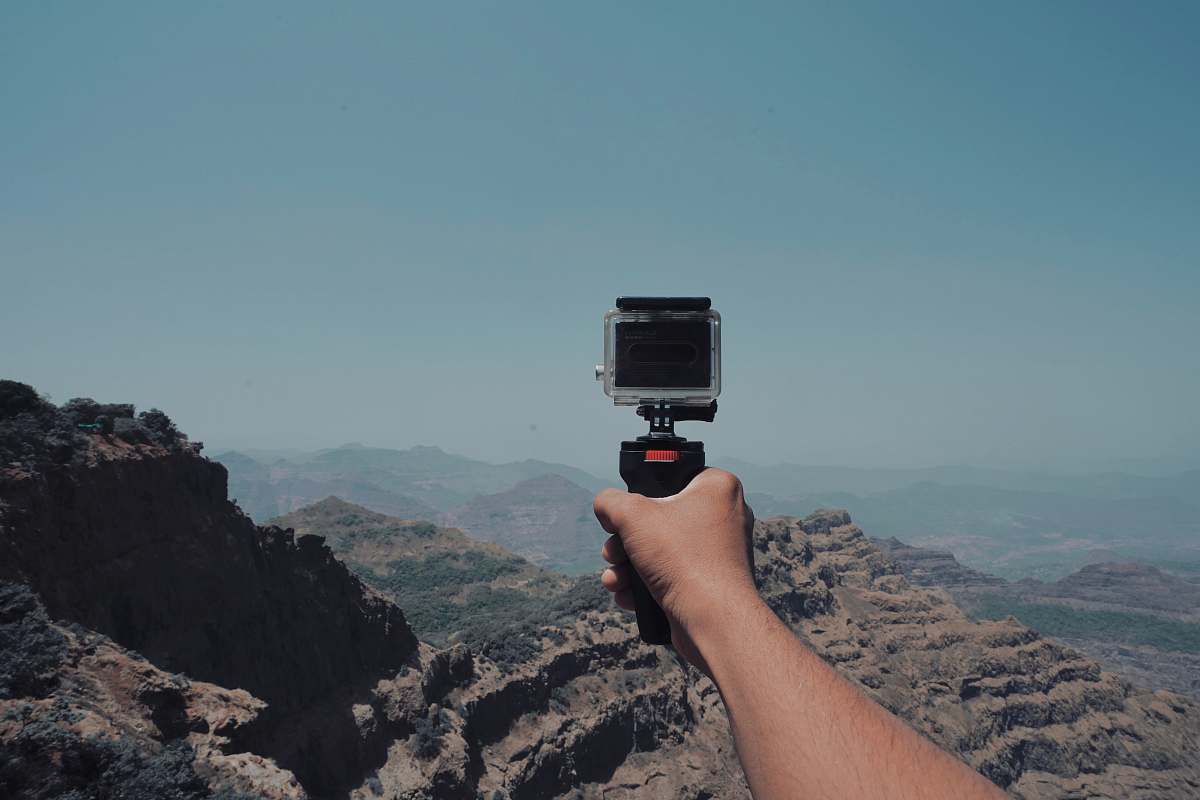 human person holding action camera near Grand Canyon photo