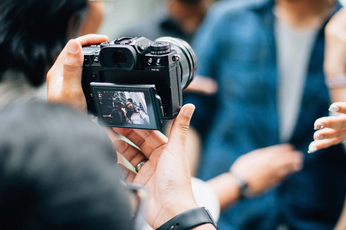 camera person holding camera electronics