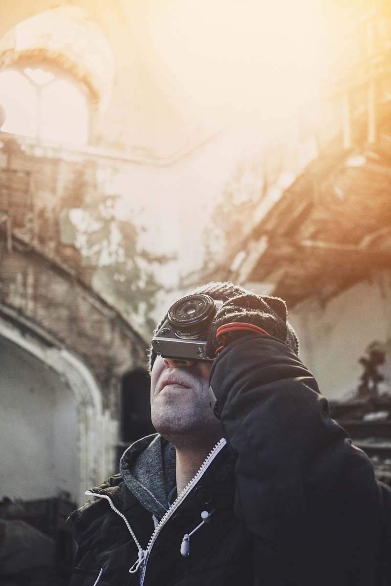 winter person holding camera looking upward photography