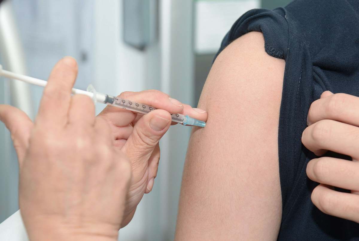 human person injecting someone on his arm people