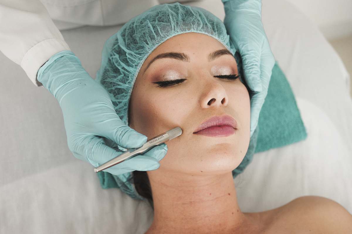 human woman doing liposuction on her face face