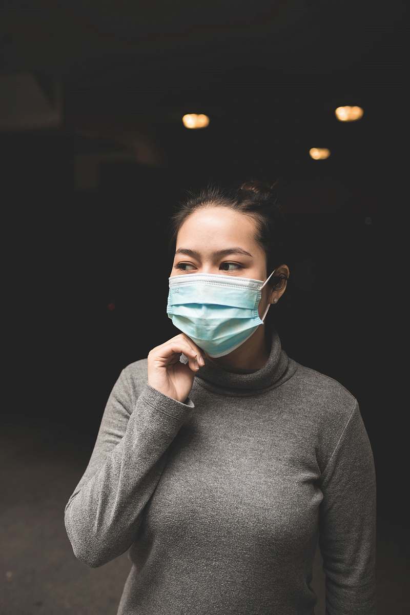 human woman wearing teal mask and gray turtle-neck shirt people