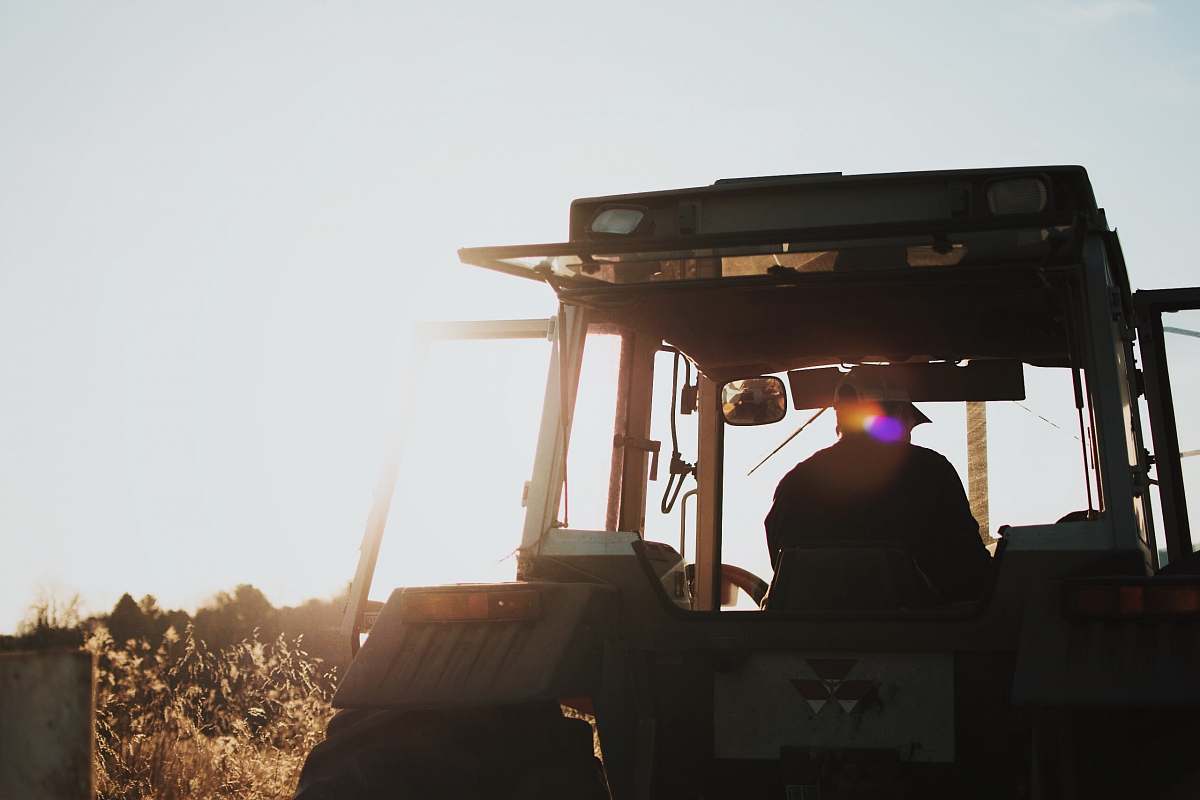 farming silhouette of man riding tractor agriculture