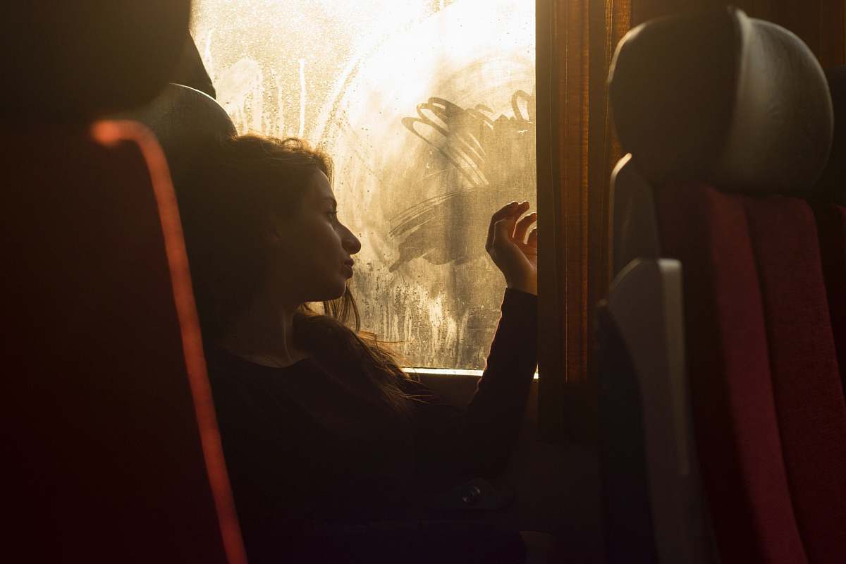train woman sitting on chair near window female