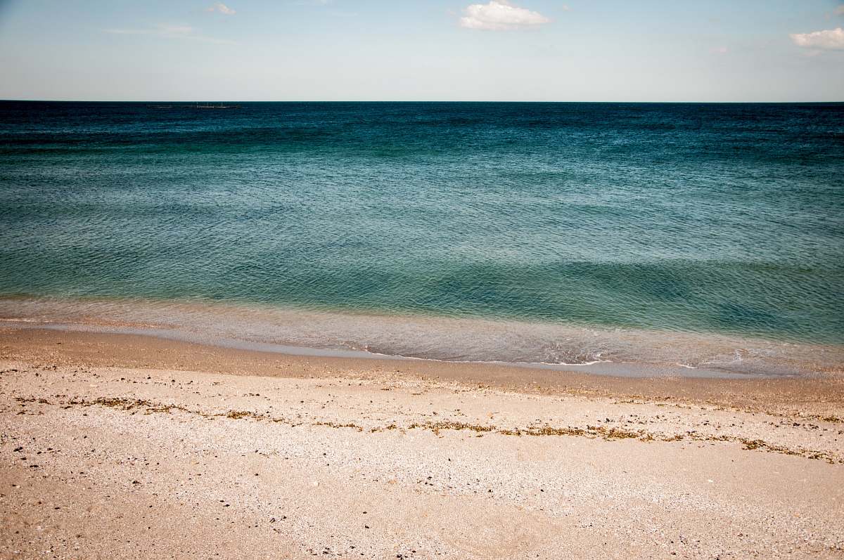 nature calm water of sea under blue and white sky during daytime photography water