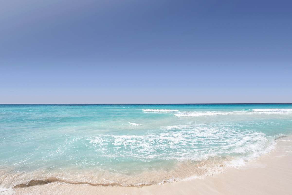 Immerse yourself in the serene beauty of a clear blue ocean gently lapping against the soft, golden sands of a Cancun beach. This picturesque scene captures the essence of paradise, perfect for travel blogs, vacation brochures, and lifestyle articles. The vibrant colors and tranquil atmosphere invite viewers to experience the warmth of a sunny day by the sea, making it an ideal choice for anyone looking to evoke feelings of relaxation and adventure.