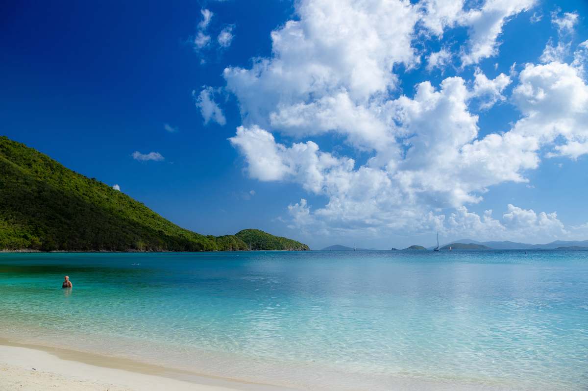 ocean person swimming on beach during daytime outdoors