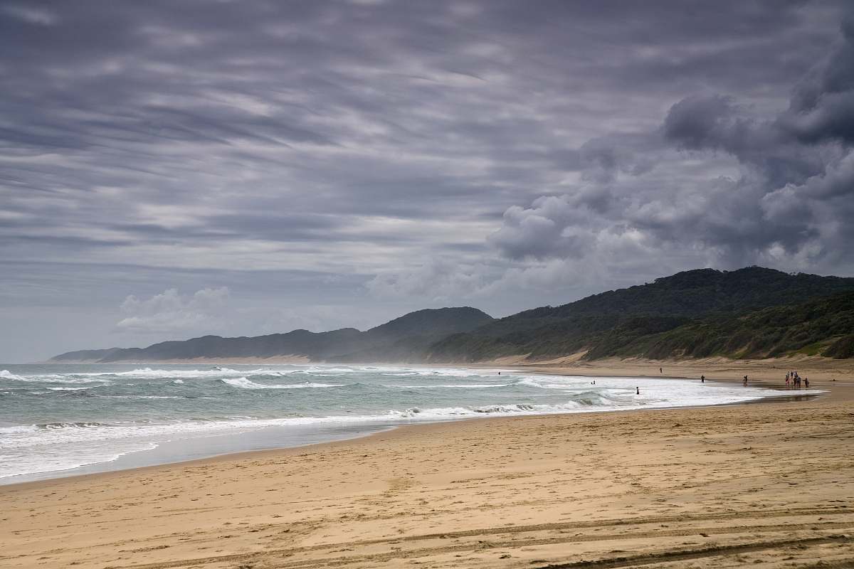 water photo of people walking in seashore ocean
