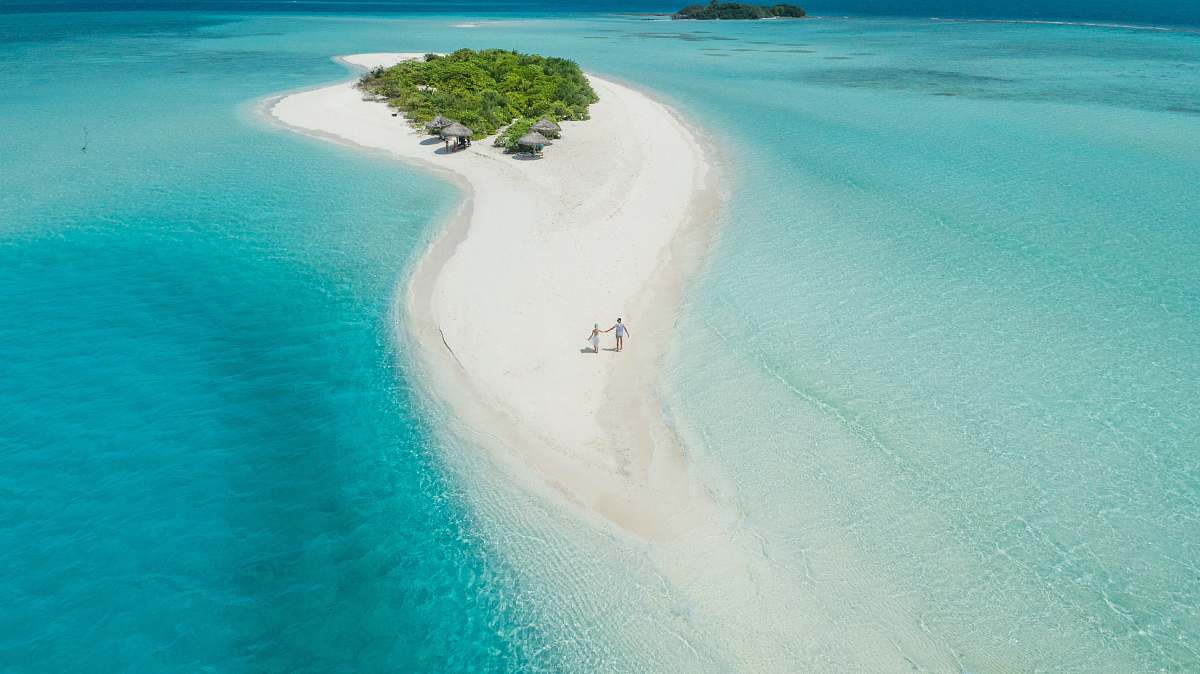 maldives two person walking on islet during daytime alifu alifu atoll