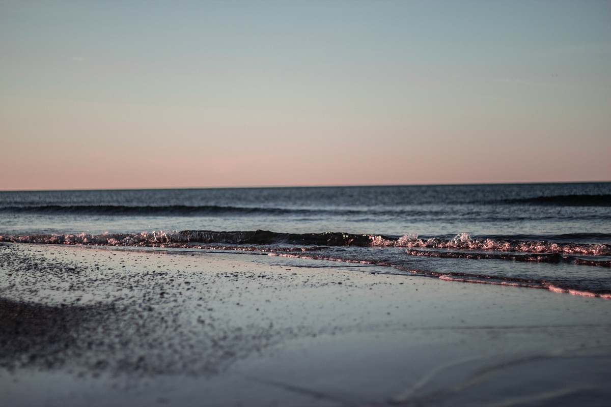 beach waves crashing on shore during daytime sea