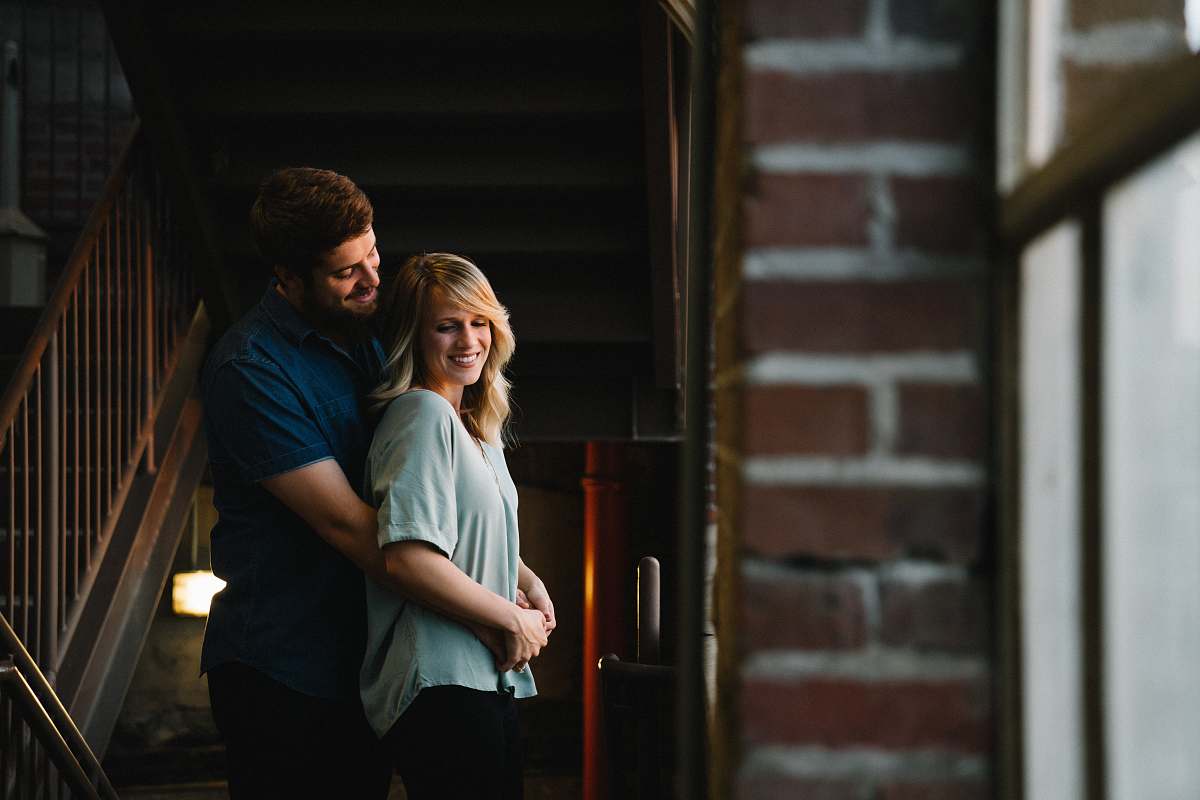 person man hugging woman from behind near stair human