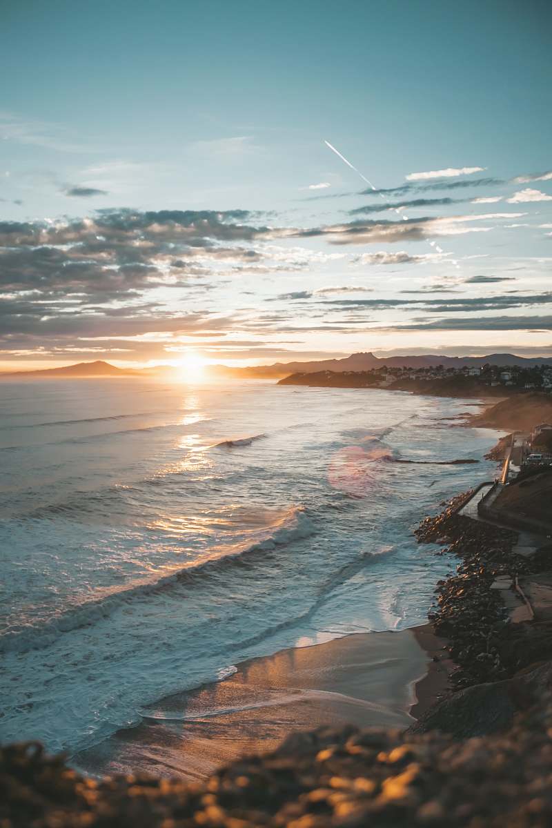 Capture the serene beauty of nature with this breathtaking photograph of a sunset casting vibrant hues across the calm ocean waters. Ideal for use in travel blogs, environmental campaigns, or relaxation-themed projects, this image evokes feelings of peace and tranquility, making it perfect for enhancing any visual content related to nature or coastal landscapes.