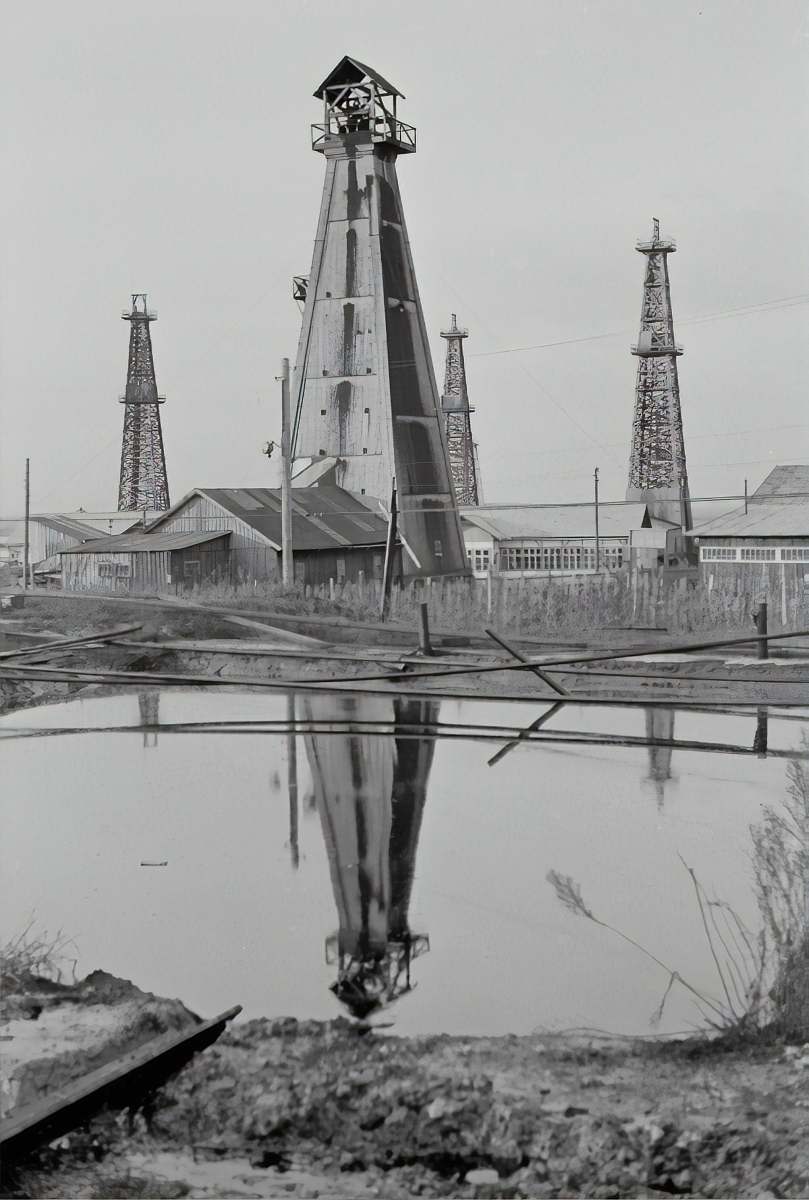 grey white and brown windmill beside body of water architecture