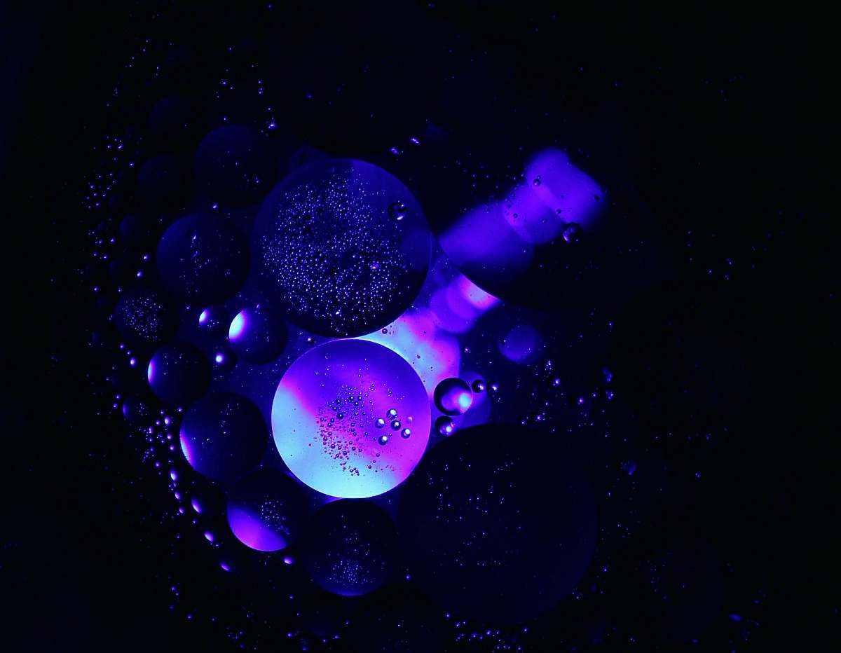 light high contract photography of blue bubbles sphere