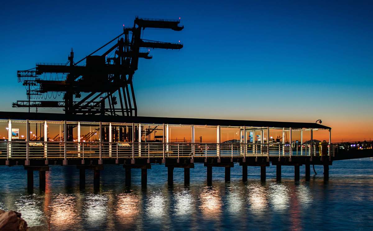 pier black wooden dock on body of water during sunset jetty bridge