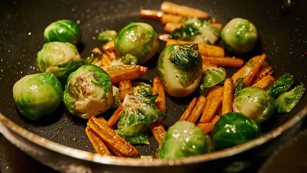food carrots and green vegetable on stainless steel strainer meal