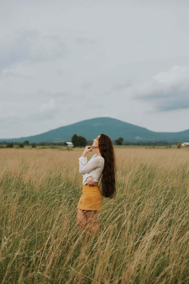 person woman standing in the middle of grass field nature