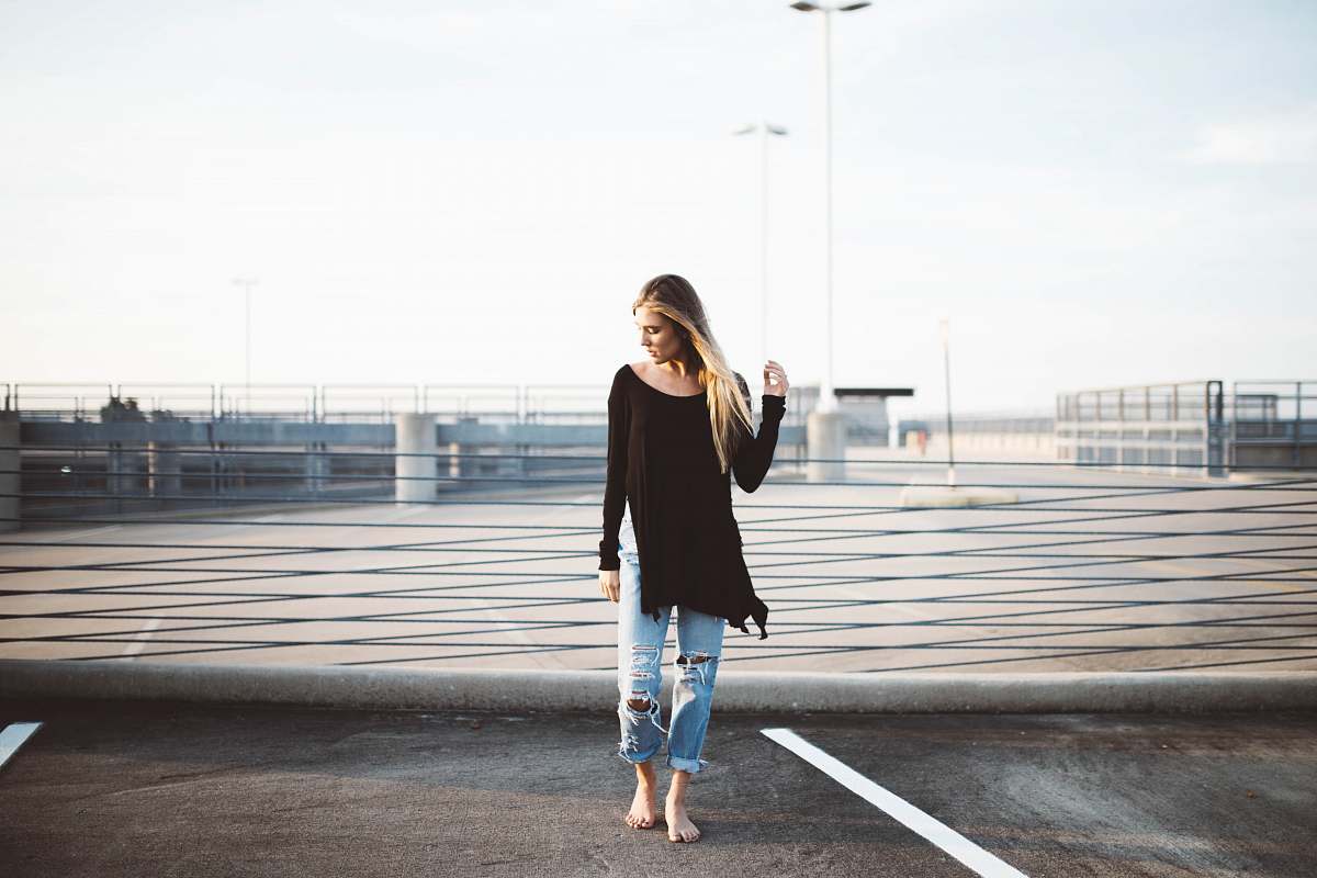 person woman standing on gray concrete pavement human