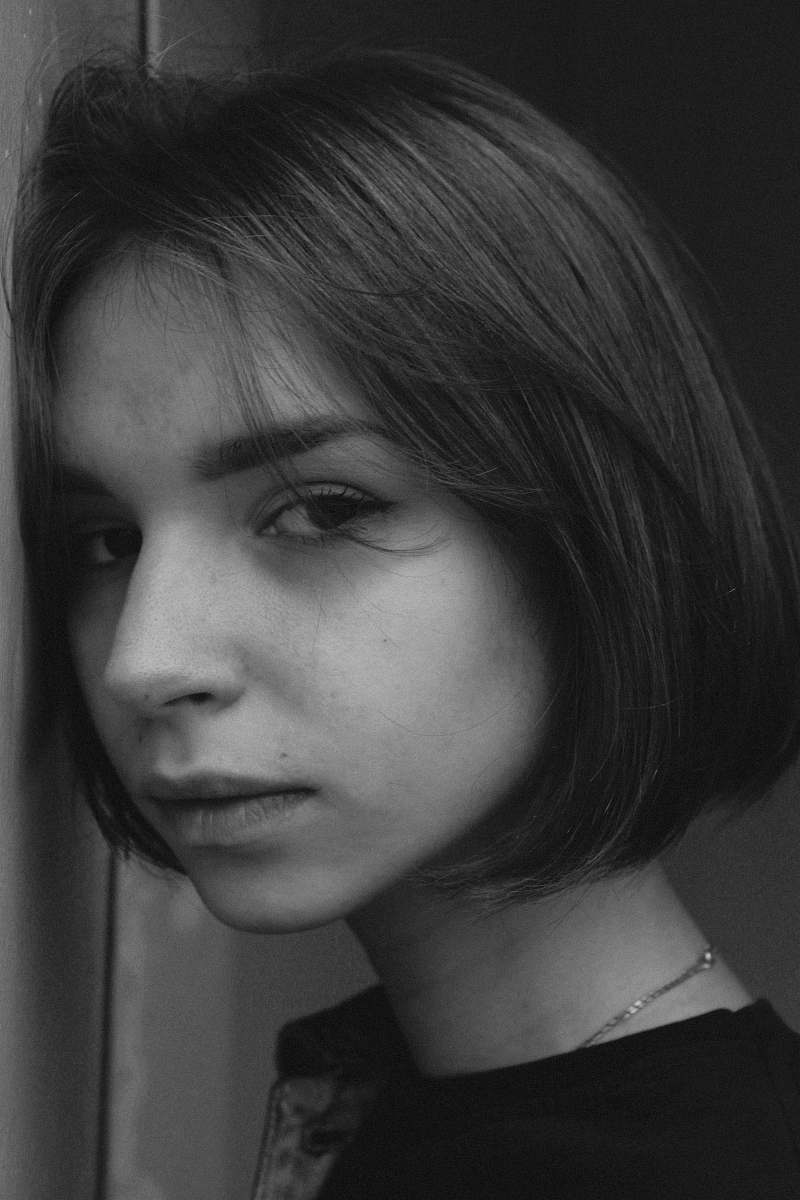 face grayscale photo of woman human