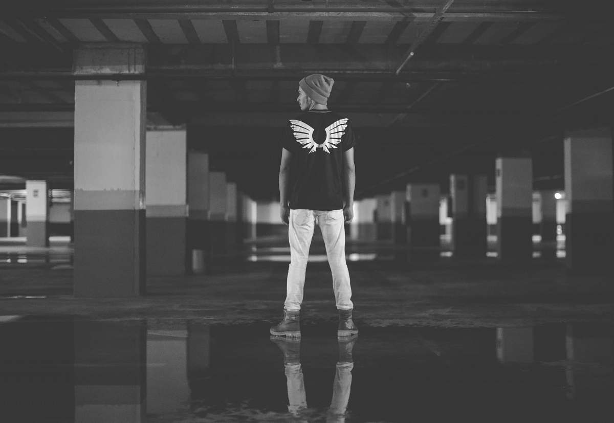 person man standing on ground near column grey