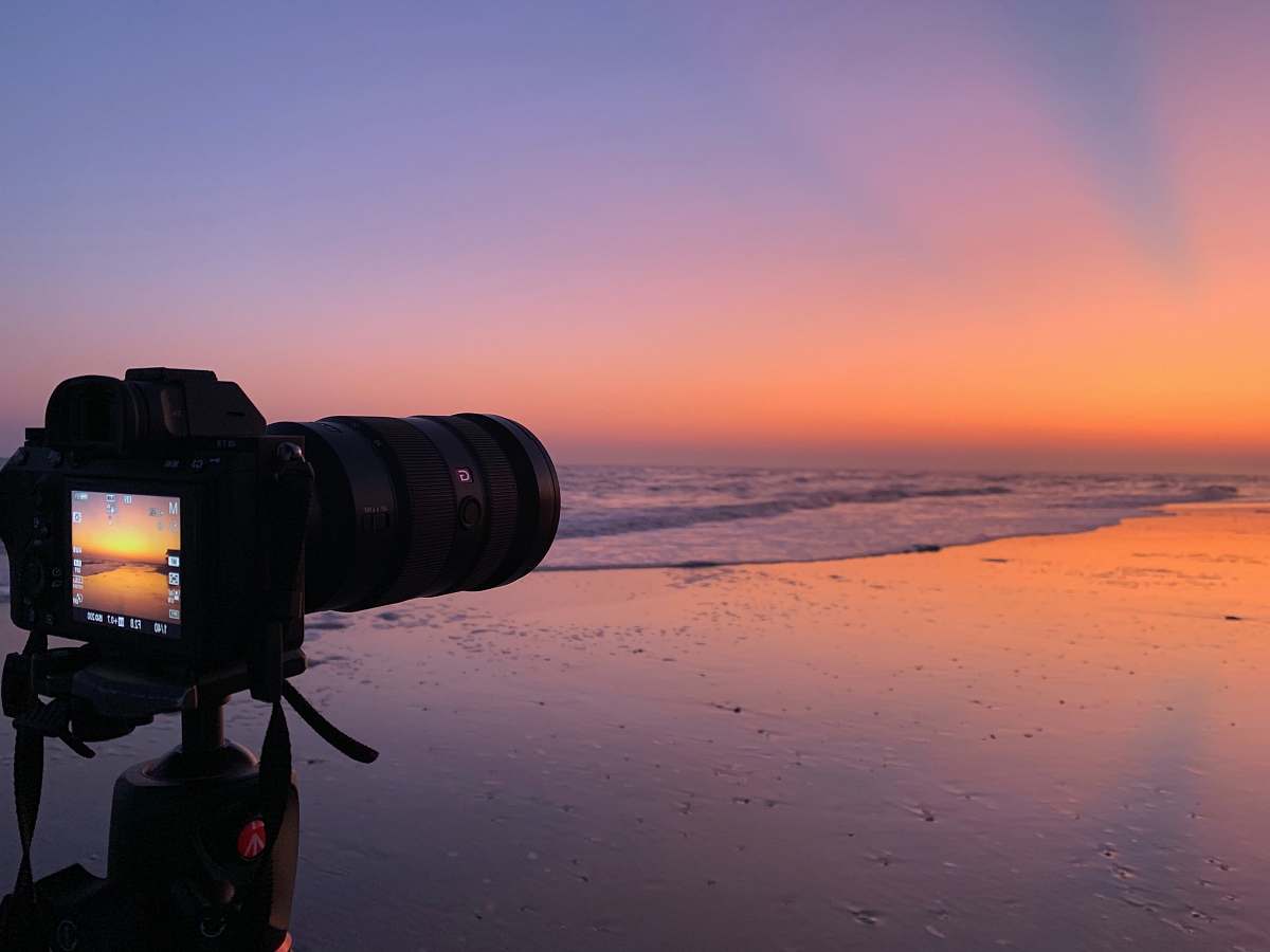 electronics black DSLR camera near body of water photo
