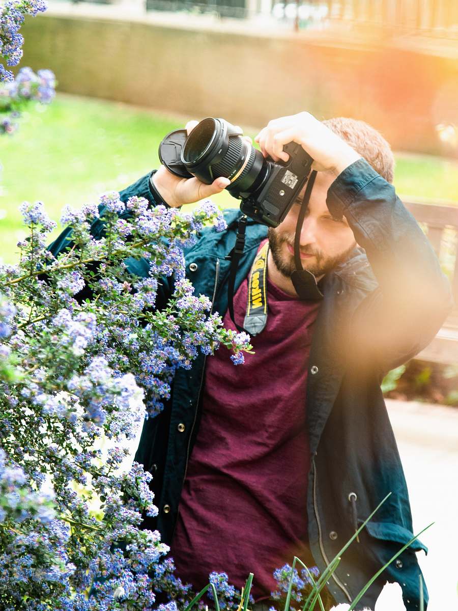 person man holding DSLR camera human