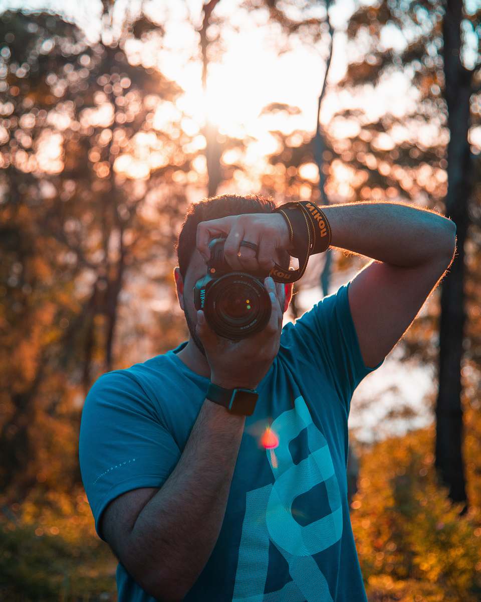person man using DSLR camera human
