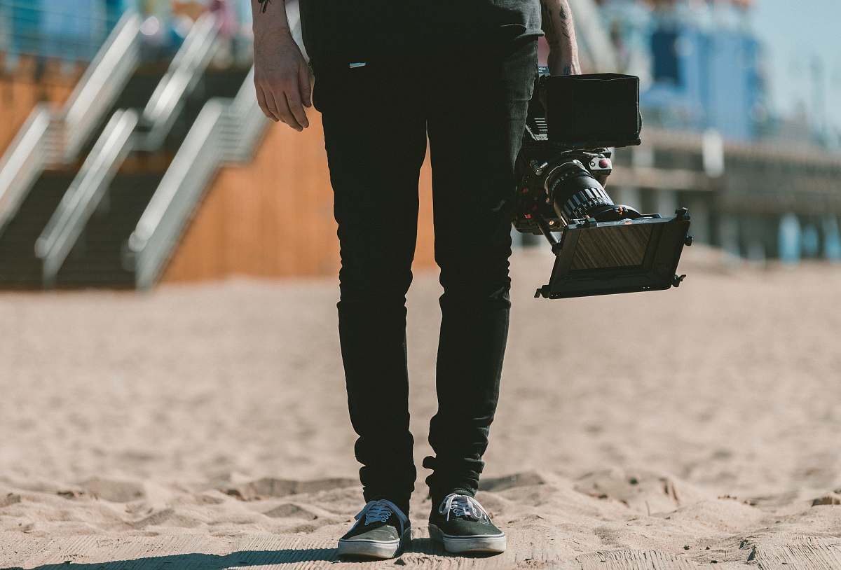 shoe person holding shoulder-mount camcorder video