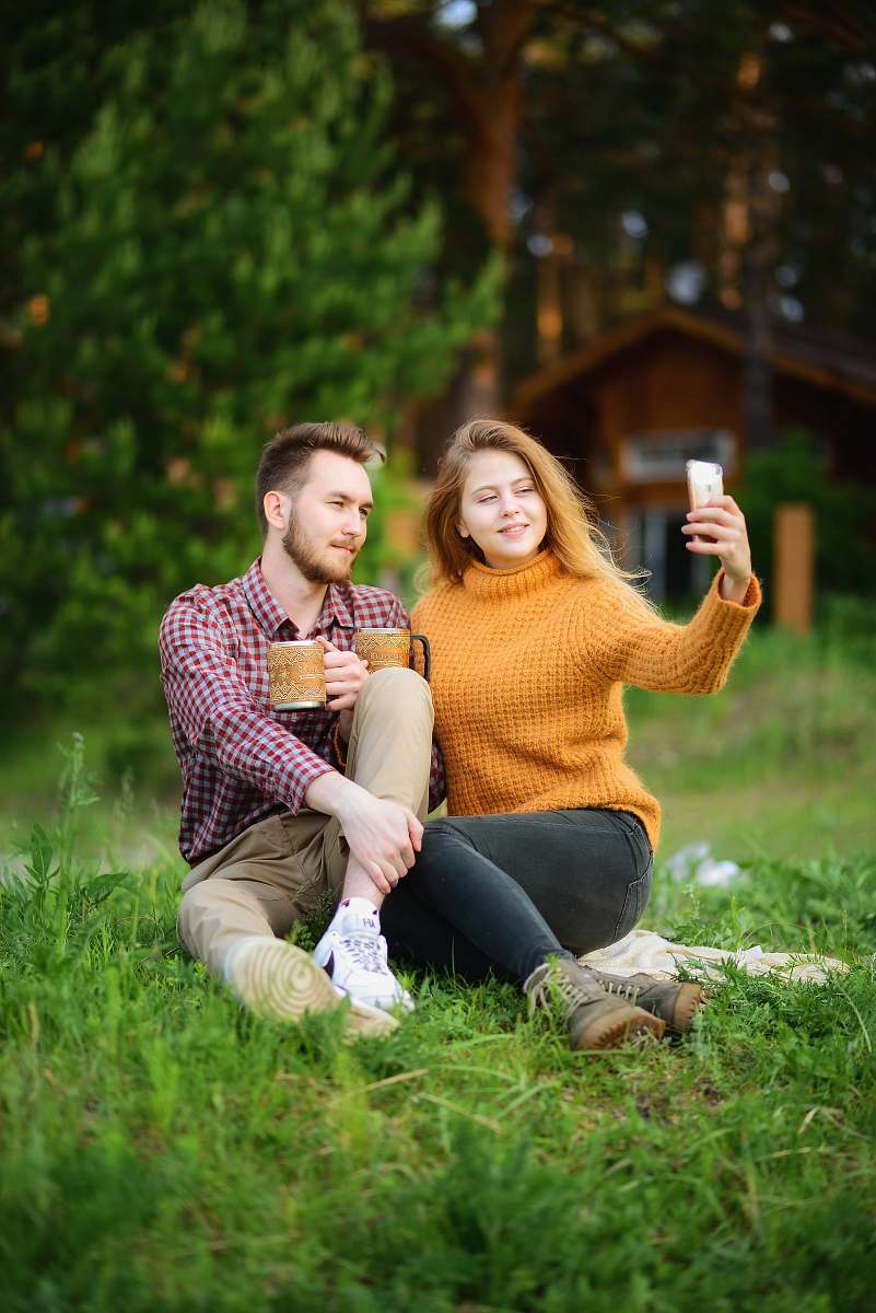 person woman taking photo of man and woman human