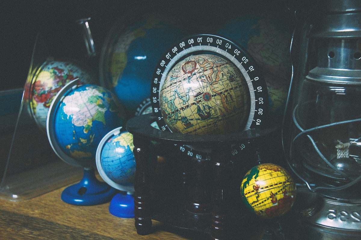 sphere assorted mini desk globes on shelf near gray kerosene lantern planet