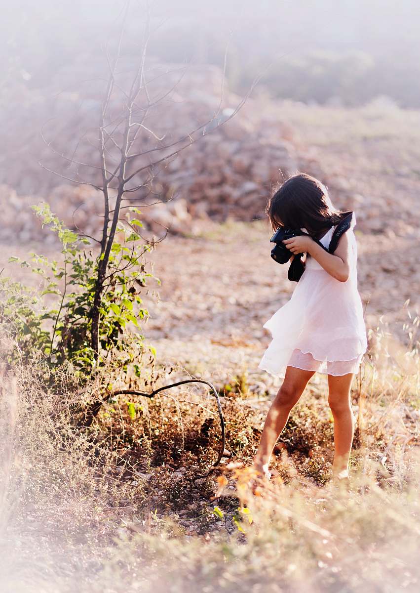 girl girl taking picture of tree branch outdoors people