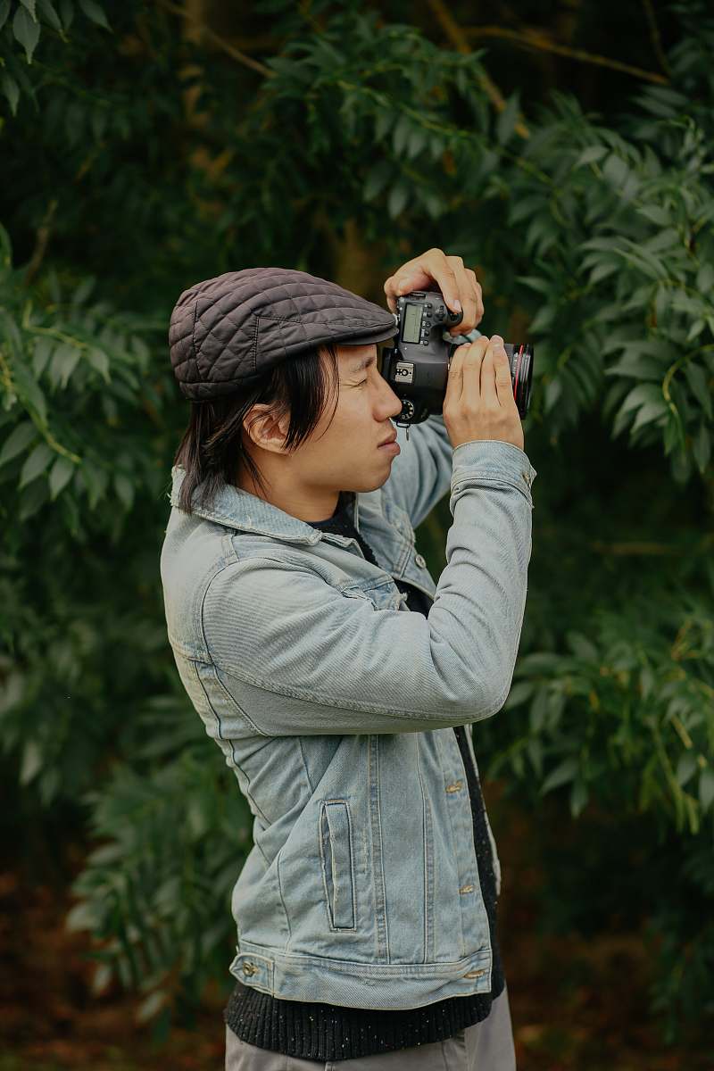 person man wearing grey jacket taking picture photo