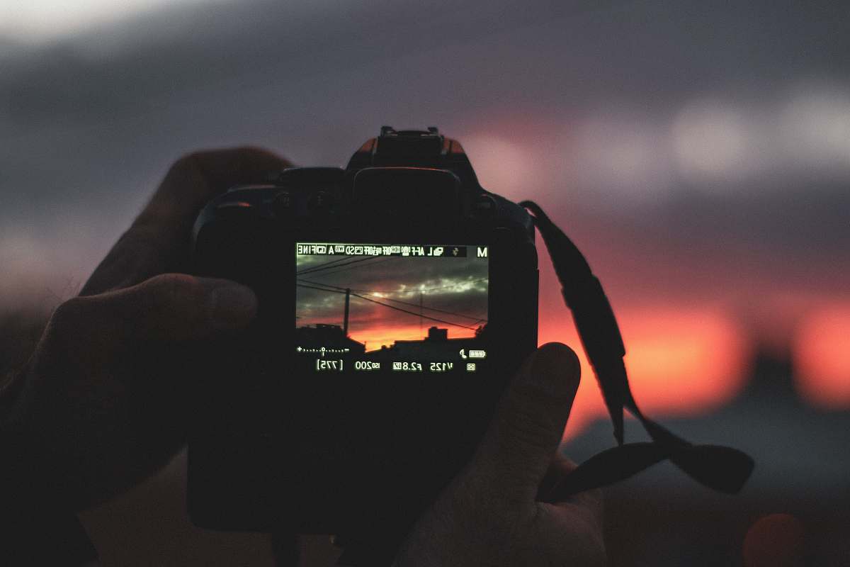 person person holds camera camera