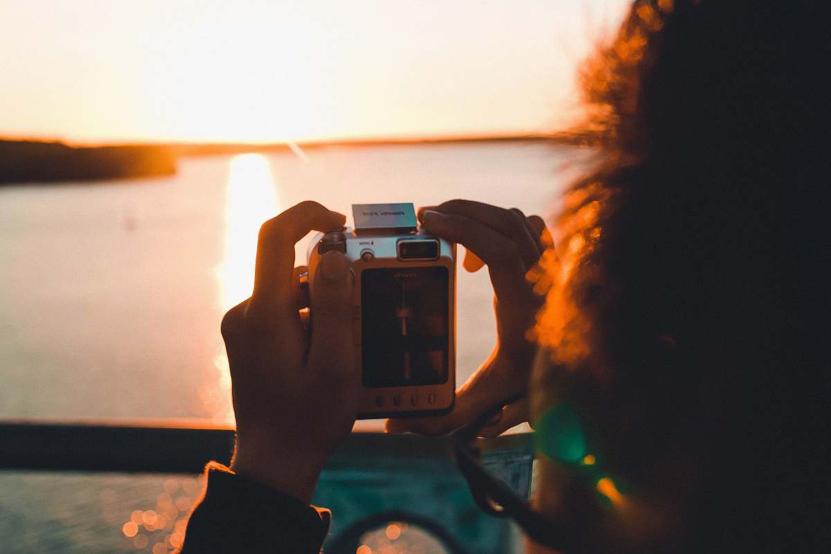 person person taking photo of sea camera
