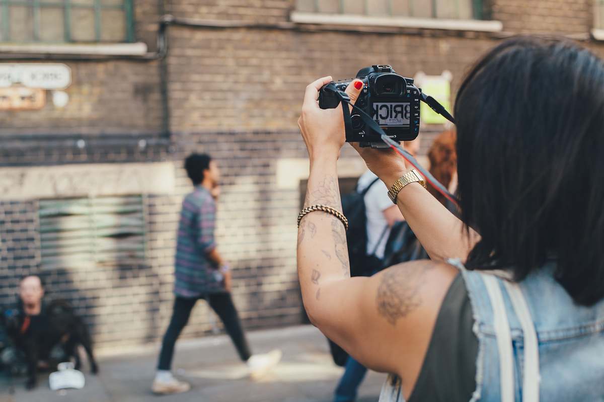person person taking photo on concrete building people