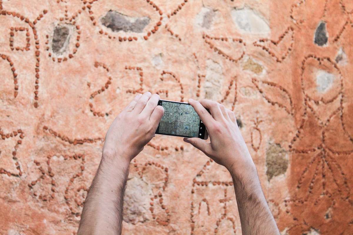 person person taking picture of wall phone