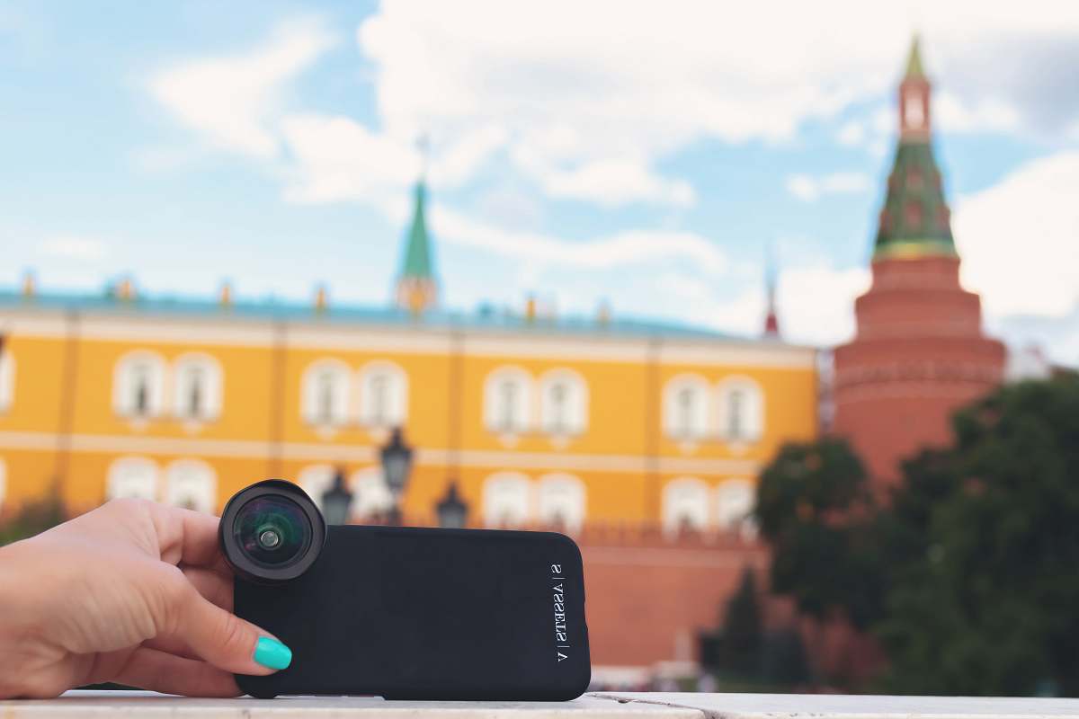 person selective focus photography of woman holding black camera with lens photo
