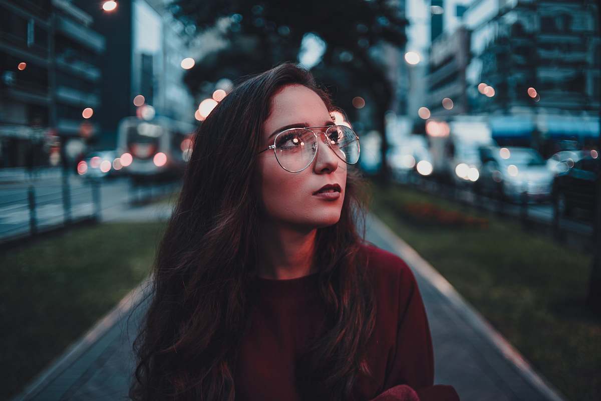 person woman in maroon sweater with eyeglasses accessories