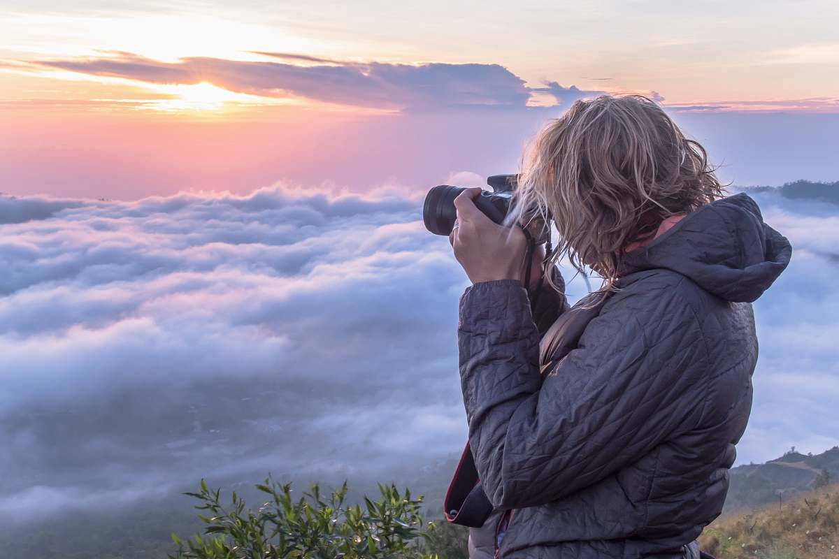 person woman taking photo of clouds mount batur