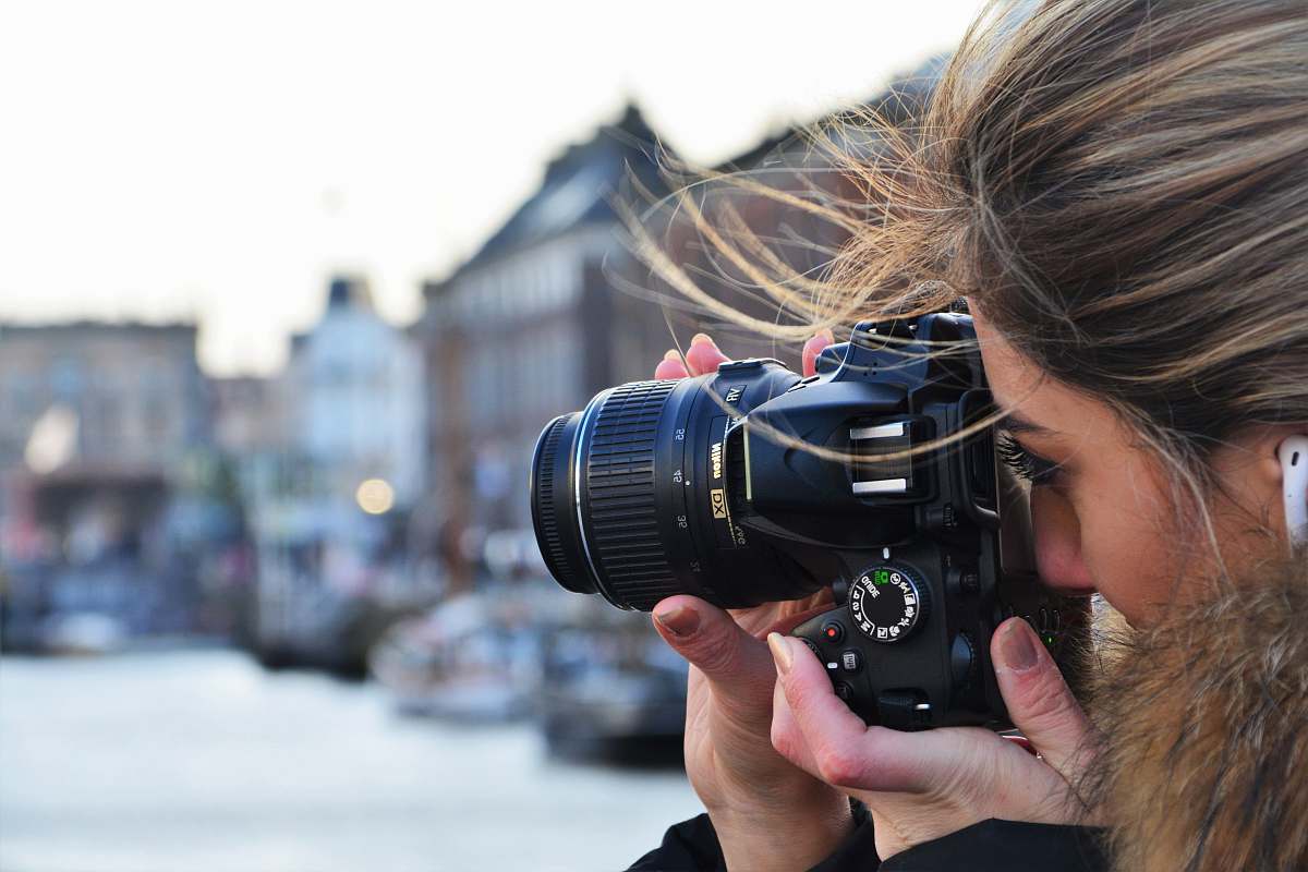 camera woman using DSLR camera electronics
