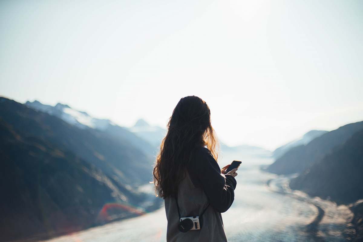 person woman using smartphone outdoors photo