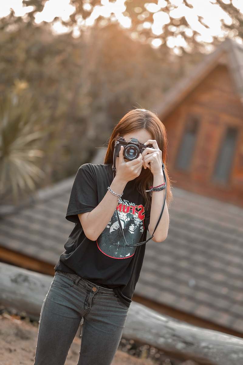 person woman with DSLR camera taking pictures accessories