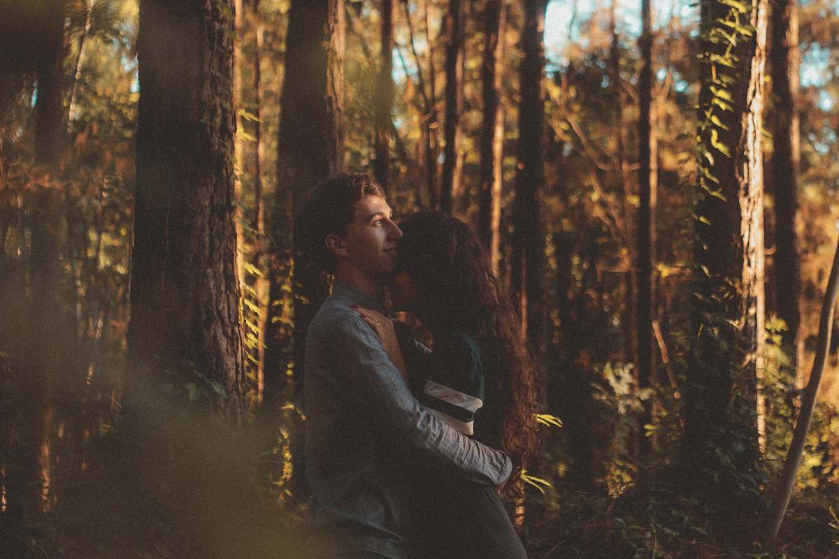 A captivating scene of a couple embracing amidst the lush greenery of a serene forest. This heartwarming image captures the essence of love and connection in nature, making it perfect for romantic articles, relationship blogs, or themed marketing campaigns. The rich textures and vibrant colors of the forest backdrop enhance the emotional depth of the moment, appealing to anyone looking to evoke feelings of warmth and togetherness.